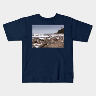 Rocks and snow on the coast of frozen sea Kids T-Shirt